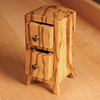 Small handcrafted bandsaw box with two drawers made from striped wood grain on a workbench
