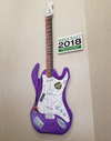 Purple electric guitar with wood grain finish and Woodcraft 2018 conference stickers on body