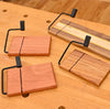 Examples of the WoodRiver cheese slicer kit shown on a workbench.