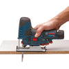Hand holding Bosch cordless jigsaw cutting through plywood panel with guide fence attached