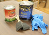 General Finishes Persian Blue milk paint, black gel stain, foam brushes, and blue nitrile gloves on wood surface