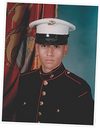 Portrait of a young man in a Marine Corps dress uniform against a flag background