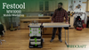 Woodworker setting up Festool MW1000 Mobile Workshop with fold-out work surface in workshop.
