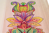 Colored floral and geometric pattern drawn on smooth wooden board surface