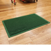 Green anti-fatigue mat on hardwood workshop floor with Boot Rug embossed corner label