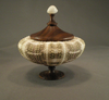 Woodturned wooden pedestal box with a sea urchin shell body and a white finial knob on top