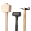 Wooden mallet, rubber mallet, and cross-peen hammer with wooden handles on white background