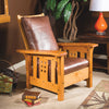 Craftsman-style Morris chair with cherry wood frame and leather cushions in living room setting