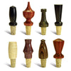 Eight turned wooden bottle stoppers with various shapes and wood finishes on cork bases.